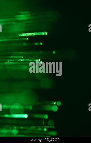 Macro shot of green fiber optic light strands. Abstract green background Stock Photo