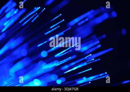 Fiber optical network cable in blue light. close up macro Stock Photo