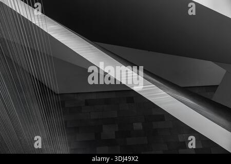 Minimalist Architectural Composition Featuring Sharp Diagonal Beams and Textured Wire Installation in Black and White. Stock Photo