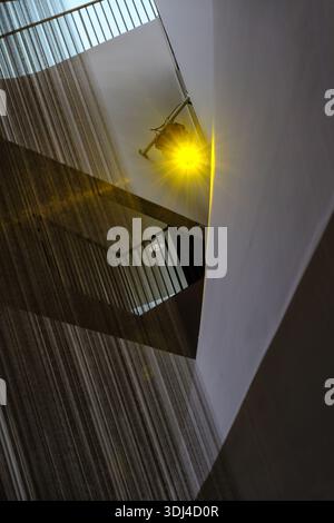 Interior Architectural Abstract with Warm Spotlights and Shimmering Vertical Textures in Modern Hallway. Stock Photo