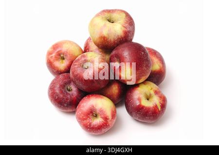 Red apples isolated on white background. Group of fresh ripe fruits stacked together. Natural healthy food concept. Autumn harvest produce. Stock Photo