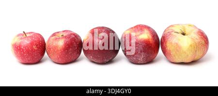 Row of red apples isolated on white background. Fresh ripe fruits aligned in straight line. Healthy food nutrition concept. Natural organic product. Stock Photo