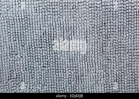 Macro shot of a soft textile surface with pile. Neutral gray background for design showing a cozy texture of fabric, carpet, or blanket Stock Photo