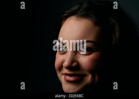 Bright Smile Portrait Of A Woman In Studio Lighting Warm, Confident Headshot Stock Photo