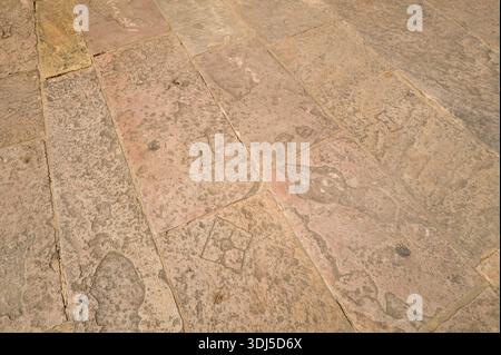 Prayagraj, India - March 21, 2024: The image shows a close-up view of weathered sandstone paving stones forming part of the ground surface at Khusro Bagh during daylight. Stock Photo