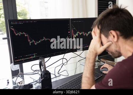 Freelance trader feeling bad and concerned about stock price decline Stock Photo