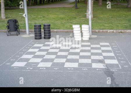 Ulyanovsk, Russia - July 25 2021: Checkers game. Gigantic black and white checkers on the asphalt. Stock Photo