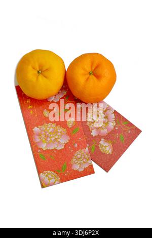Two Lukan mandarin oranges variety, Chinese New Year red packets decorated with peony flowers and blessings for good luck, isolated on white Stock Photo