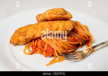 Piccata Milanese Pan Fried Veal Cutlet With Spaghetti and Pomodoro Tomato Sauce Stock Photo