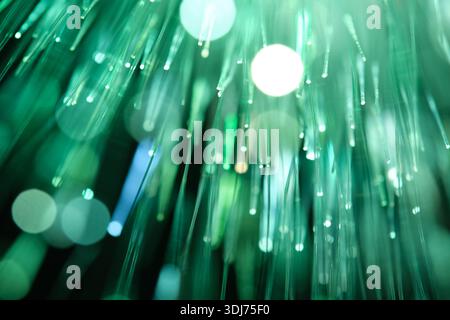 Abstract digital background featuring blue and turquoise fiber optic lights with circular bokeh, ideal for telecommunications and big data concepts Stock Photo
