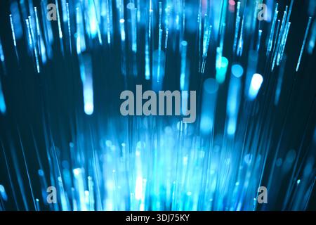 Blue glow fiber optic cable is data transmission concept Stock Photo