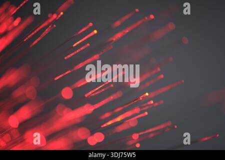 Red fibre optic light strands close-up macro photography. Abstract background Stock Photo