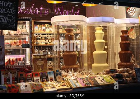 Milk, dark and white chocolate fountain displayed at a market stall selling sweets and chocolates in the famous Great Market Hall in Budapest, Hungary Stock Photo