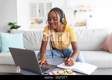 Intelligent black woman attending online class from home Stock Photo