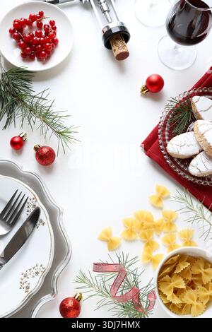 Christmas table set with Christmas decorations, tableware, food, and drinks on a white background. Christmas season and holidays. Christmas concept. Stock Photo