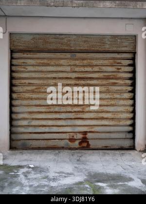 Rusty Garage Door and Crumbling Wall Stock Photo