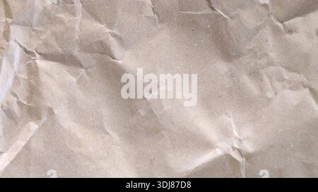 High quality textured background of old crumpled brown kraft paper with wrinkles and creases Stock Photo