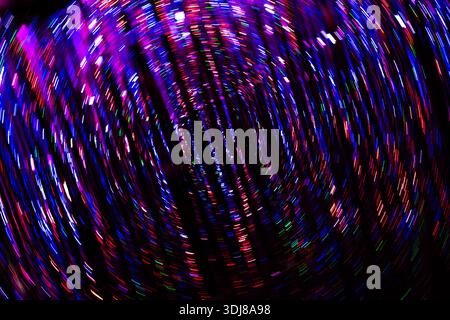 Full frame colourful psychedelic background of colourful lights or glitter spinning in a circular vortex motion Stock Photo