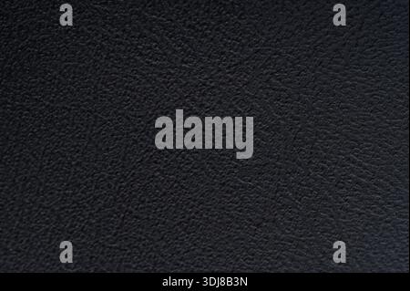 Close-up view of black material surface displaying subtle textures and patterns that evoke depth and interest. Stock Photo