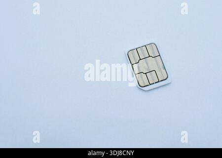 Close-up of SIM card chip isolated on white background with copy space. Concept of mobile communication, telecom, data security, smartphone technology Stock Photo