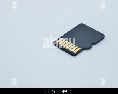 Micro SD memory card isolated on white background. Portable digital storage for data, files, photos and video. Technology, electronics and data backup Stock Photo