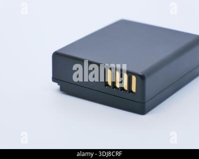 Rechargeable camera battery pack with gold contacts isolated on white background. Power supply for digital cameras and devices. Photography, electroni Stock Photo