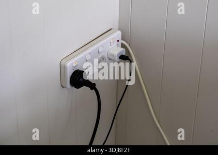 Wall Power Outlet Multiple Connected Cables Stock Photo