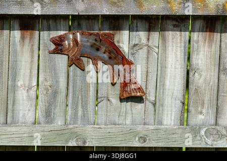 Rusty Metal Fish Decoration Wooden Fence Stock Photo