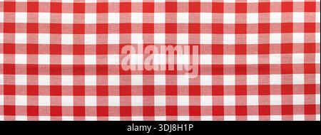 Gingham checkered tablecloth fabric with a pattern of red and white squares Stock Photo