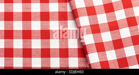 Red and white checkered fabric with folded textile texture provides a rustic background Stock Photo