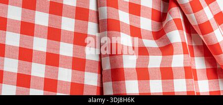 Red and white gingham fabric showing checkered pattern and soft folds Stock Photo