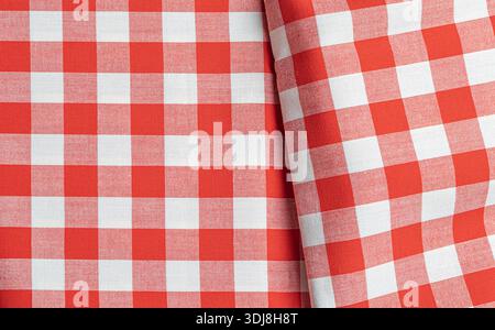 Red and white checkered fabric creating a classic gingham tablecloth texture Stock Photo