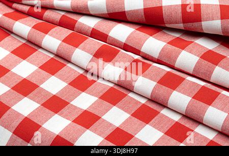 Red and white checkered fabric with creases and folds creating a textural background Stock Photo