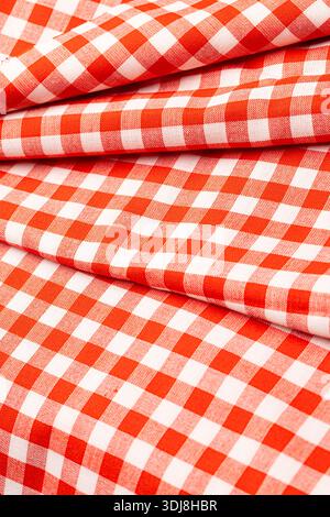 Red and white checkered gingham pattern fabric creating a textile background Stock Photo