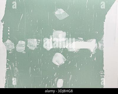 Drywall wall preparing for painting with spackle and joint compound during home renovation Stock Photo
