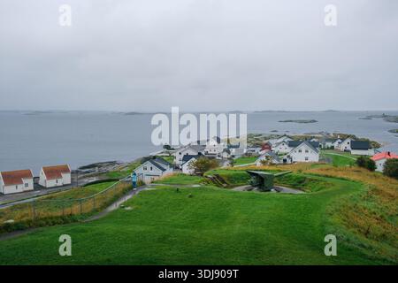 View of an old cannon from World War II on a bunker in the small Norwegian coastal town of Bud in rainy weather. Stock Photo