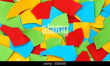 A vibrant, abstract background texture made of colorful torn paper pieces. Close up. Stock Photo
