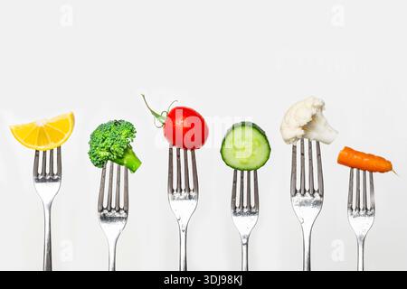 Fruit and vegetable of silver forks against a white background concept for healthy eating, dieting and antioxidant Stock Photo