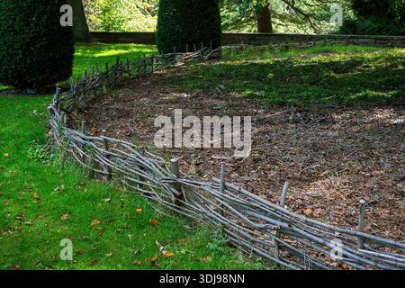 Wicker fence in an English garden Stock Photo