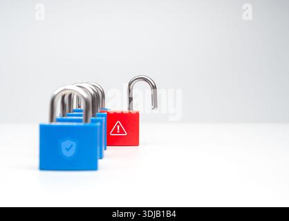 Concept of cybersecurity risk and data breach with a row of locked blue padlocks and one red unlocked padlock with warning symbol on white background, Stock Photo