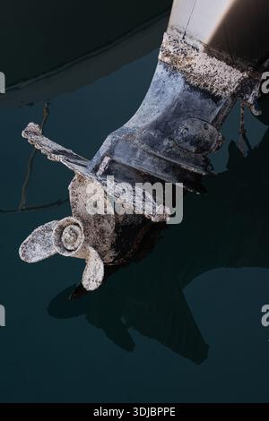 An underwater shot of a severely fouled boat propeller and shaft, indicating a need for urgent maintenance and antifouling treatment. Focuses on marin Stock Photo