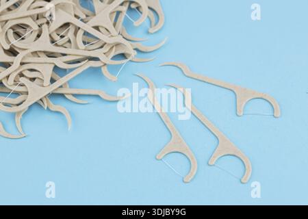 Eco friendly corn starch dental toothpick with dental floss on blue background. Stock Photo
