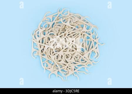 dental floss pick on the blue background. Stock Photo