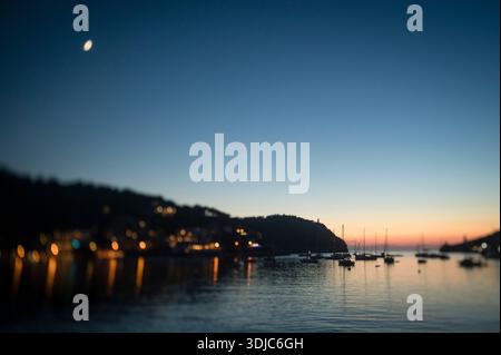 Moon Over Harbor at Dusk in Mallorca Stock Photo