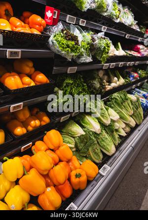 Close up of peppers and lettuces on a shelves in the grocery store. Stock Photo