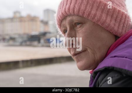 Older woman contemplating urban life Stock Photo