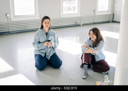 Two young women talking and laughing in studio Stock Photo