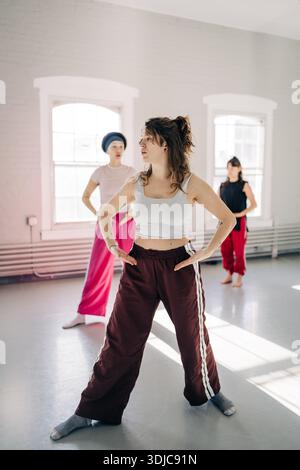 Three women dancers working on choreography in a bright studio Stock Photo