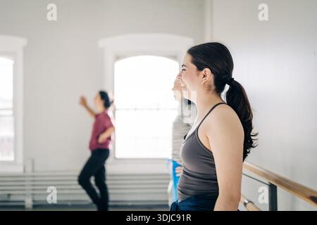 Woman smiling in ballet class enjoying hobby Stock Photo
