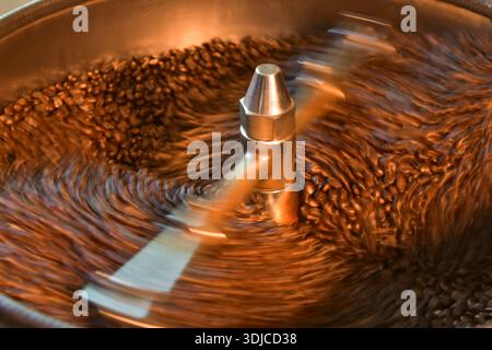 Close-up of Coffee beans roasting in a factory coffee roaster, Thailand Stock Photo
